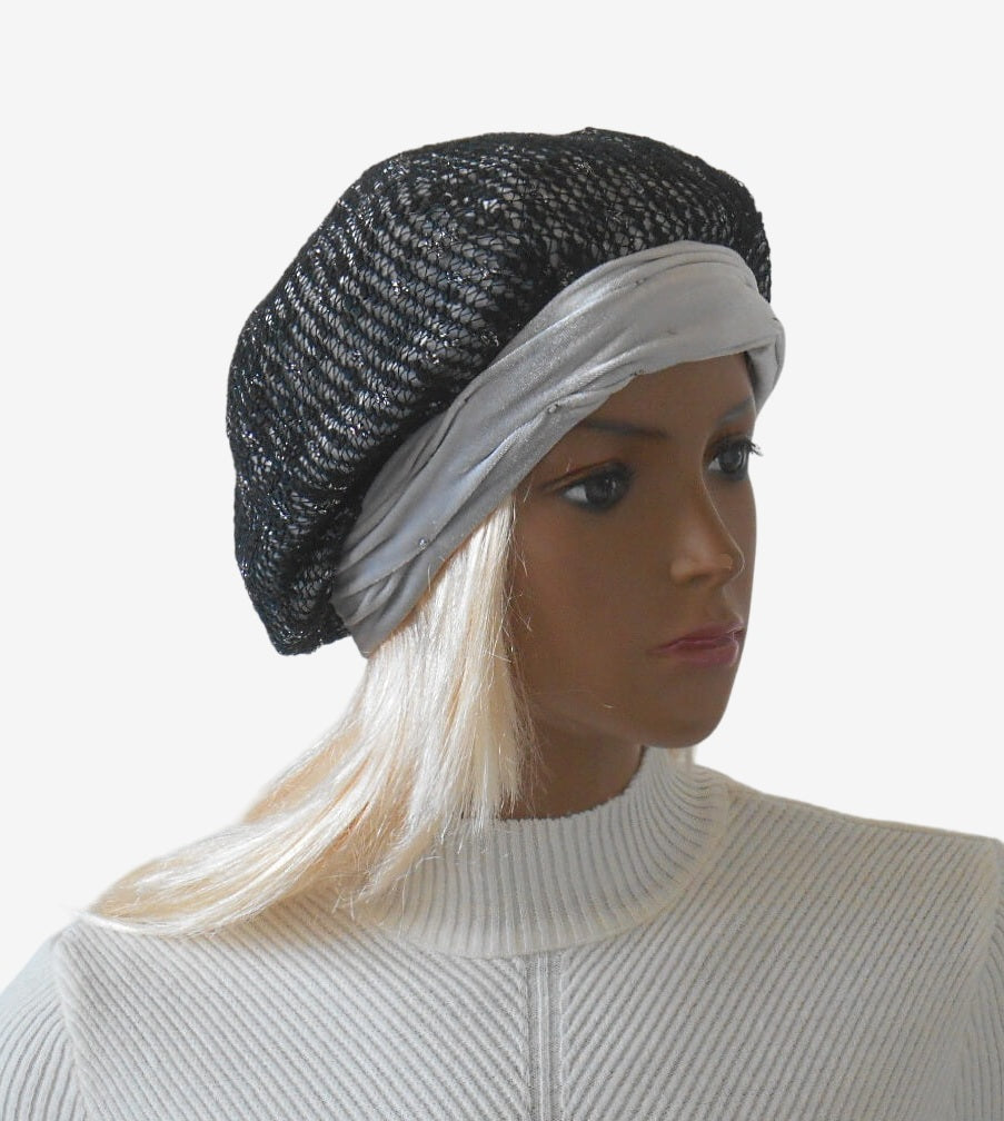 Three-quarter view of women’s light gray velour and black mesh beret with elegant draped detail