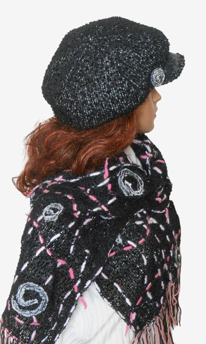 Side view of women’s black Newsboy cap with removable brooch and long fringe scarf