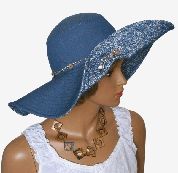 Three-quarter right view of women’s wide-brim denim hat, featuring decorative brooch pin and raised brim