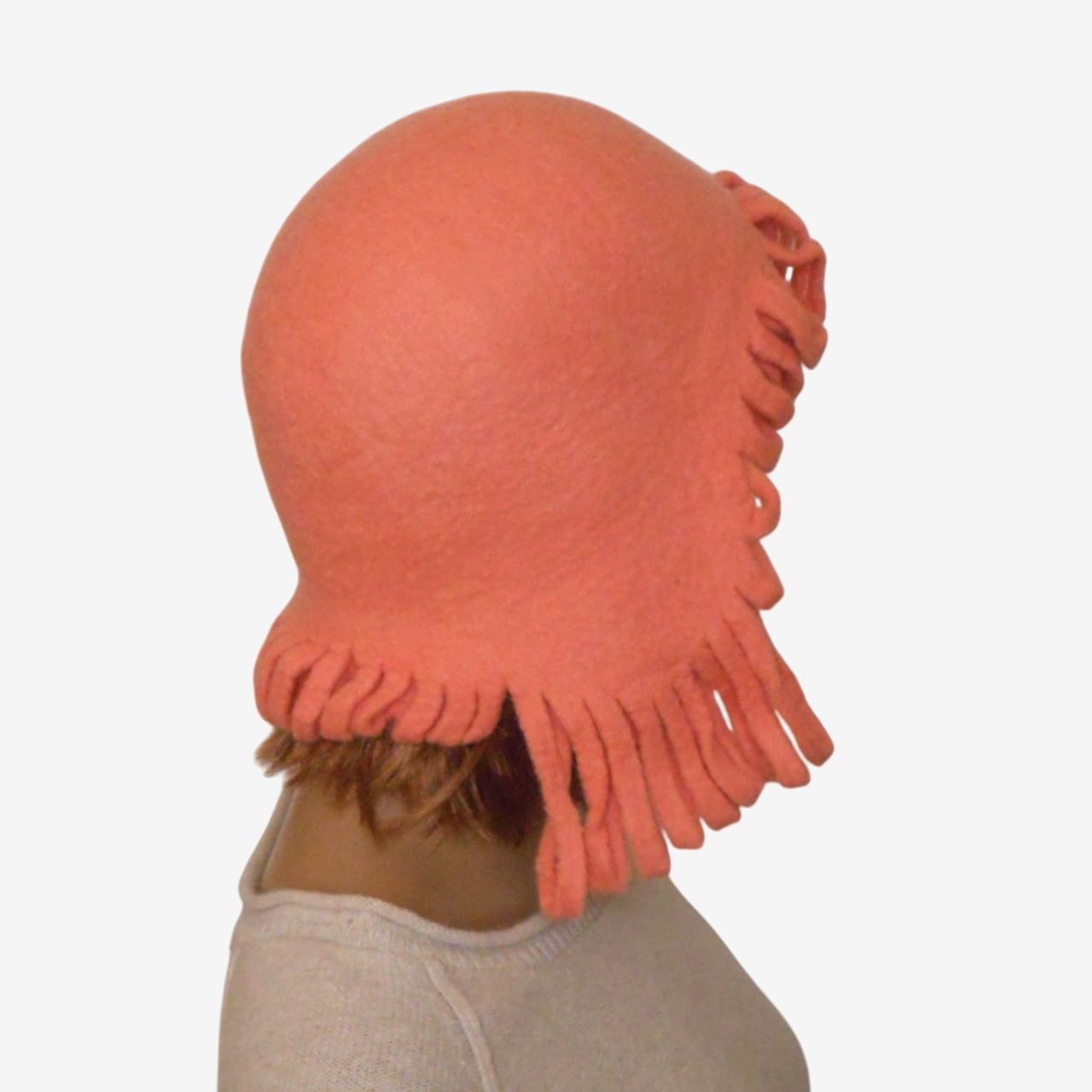 Side view of women’s coral wool trapper hat with ear flaps – cozy winter hat