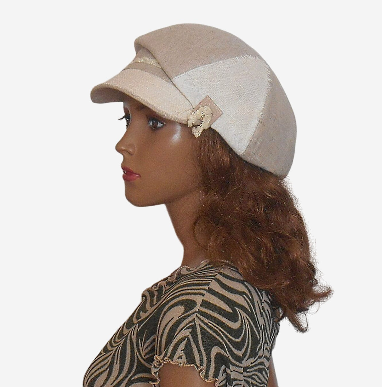 Side view of womens beige linen newsboy cap showing white side panel and button
