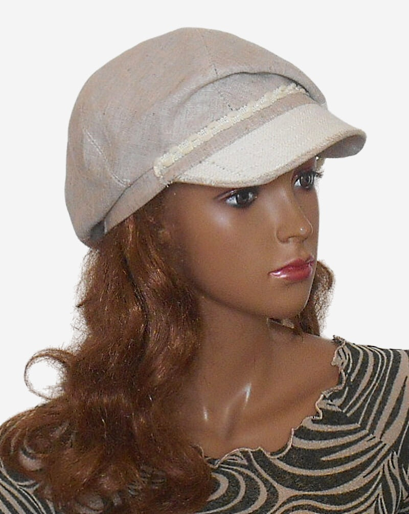 Womens beige linen newsboy cap three quarter view with visor white panel and button accent