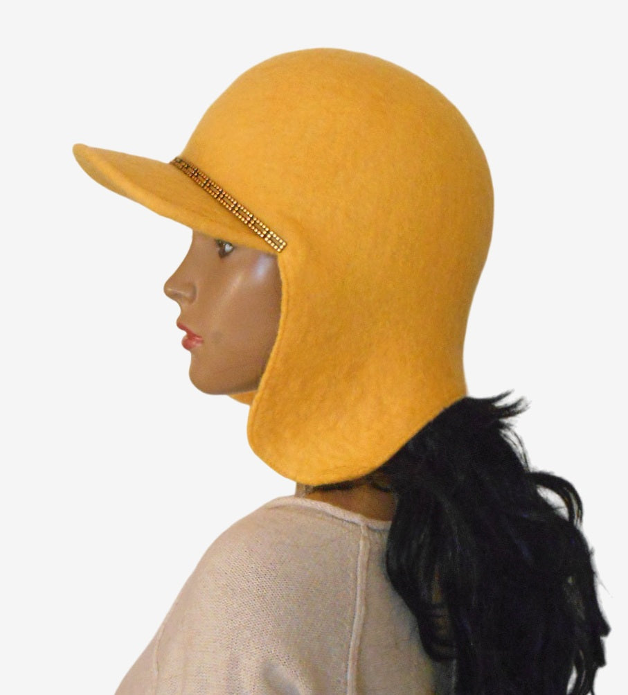 Yellow felt trapper hat with ear flaps and visor, side view