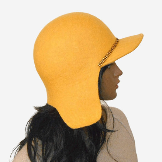 Yellow felted trapper hat with chain decoration on the visor